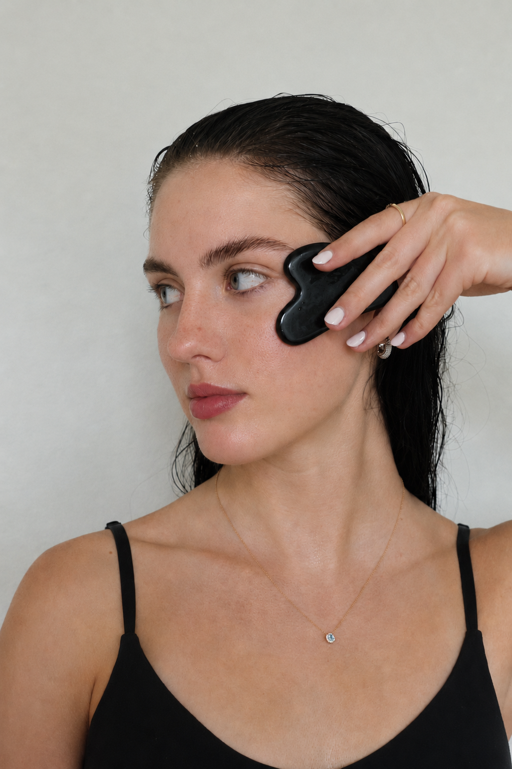 Using the Black Obsidian Gua Sha along the jawline